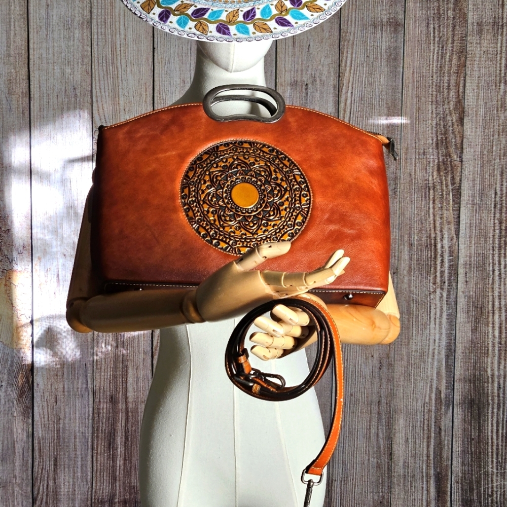 Leather handbag with medallion detail; handle or removeable shoulder strap.